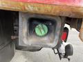 A 2011 Dodge Ram 5500 fuel filler neck with a green cap visible inside a rusted housing