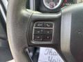 Close-up of a steering wheel with control buttons including voice command and phone options for a 2013 RAM 5500