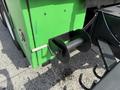 Close-up of a black and green component on a 1996 Kenworth T800 featuring a cylindrical spool connected to a metal arm