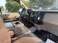 Interior of a 2009 Ford F-550 featuring a gray dashboard and seating with a central console and controls visible in the foreground