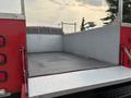 A 2015 Chevrolet Silverado 3500HD with a flatbed featuring a diamond plate surface and metal side rails