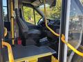A 2017 Ford Transit-350 interior featuring a driver's seat, a steering wheel, dashboard controls, and yellow safety handrails