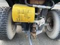 A 2021 John Deere L Series (S) featuring a yellow hydraulic cylinder and wheels with visible tire tread
