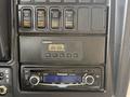 Dashboard controls of a 2013 International 4300 featuring buttons for cruise control and a Panasonic MP3 player with a digital display