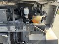 Engine compartment of a 2012 Ford Econoline with visible coolant reservoir and other components including hoses and wires