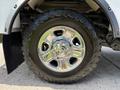 A close-up of a chrome wheel from a 2020 Ram 2500 featuring an aggressive tread pattern and a shiny finish