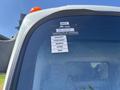 A 2016 Isuzu NPR-HD truck with a certificate of approval sticker visible on the window listing months January through May