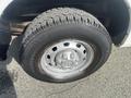 Close-up of a tire mounted on a metallic wheel from a 2012 RAM 2500 featuring a tread pattern suitable for rugged terrain
