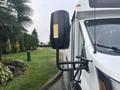 A 2021 Ford Transit-350 with a large side mirror mounted on the passenger side