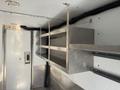 Interior view of a 2017 Freightliner MT45 with metal shelving units mounted against the wall