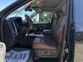 2015 RAM 1500 interior with brown leather seating and dashboard controls visible showing modern design and spacious layout
