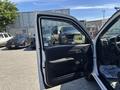 A 2011 Chevrolet Colorado with an open driver's side door showcasing the interior and dashboard