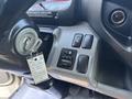 Close-up of the dashboard controls in a 2018 Hino 195 including the ignition key and mirror adjustment buttons