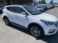 2018 Hyundai Santa Fe in white with a sleek design and alloy wheels prominently displayed
