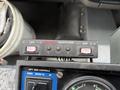 Control panel with buttons marked OFF and labeled LEFT SIDE CONTROLS BROOM TILT with a gauge below