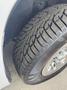 Close-up of a 2013 Chevrolet Silverado 1500 tire featuring a distinct tread pattern and shiny alloy rim