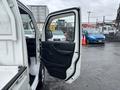 A 2008 Suzuki Carry with an open driver's door revealing the interior and dashboard details