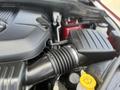Engine compartment of a 2015 Jeep Grand Cherokee featuring a black air intake system and various mechanical components