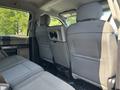 Interior view of the back seat of a 2019 Ford F-550 showing two rows of seats with a center console and headrests