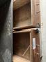 Open wooden drawers with metal handles and a label reading "HAND TOOLS" on the top drawer, revealing empty compartments inside