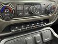 Close-up of the dashboard controls of a 2017 Chevrolet Silverado 1500 featuring climate controls and various drive mode buttons
