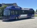 A 2018 Grande West Vicinity bus painted in blue and white with "TRANSIT" and "CLEAN AIR VEHICLE" on its side