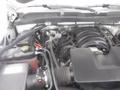 Engine compartment of a 2015 Chevrolet Silverado 1500 showcasing various components including the air intake manifold and battery connections