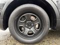 A black alloy wheel of a 2019 Ford Explorer featuring a five-spoke design and all-season tire with visible tread patterns