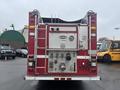 A red 2006 E-One Fire Truck with a silver and gray rear panel featuring various hoses valves and compartments