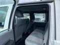 Interior view of a 2015 Ford F-550 showing the rear seating area with gray fabric upholstery and a spacious cabin design