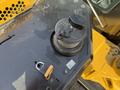 Close-up of the fuel cap on a 2022 Caterpillar 306 excavator showing a black plastic cap with a lever and a small lock attached
