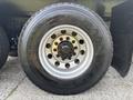 Close-up of a 2013 International WorkStar tire featuring a shiny silver rim with multiple bolts and the Goodyear Ultra Grip RTD tire tread design