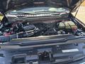 Engine compartment of a 2022 Ford F-350 SD featuring a large engine with visible wires hoses and components