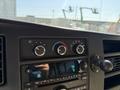 Dashboard controls of a 2017 Chevrolet Express featuring temperature and fan speed dials along with a radio display and buttons