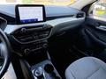 Interior view of a 2020 Ford Escape featuring a modern dashboard touchscreen controls and a sleek gear shift with a cup holder
