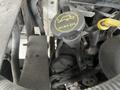 Close-up of the engine components of a 2011 Ford Econoline showing wires and a yellow dipstick with markings