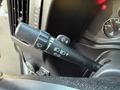 Close-up of a 2015 GMC Savana multifunction lever for windshield wipers and turn signals with various settings and symbols
