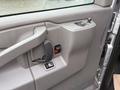 Interior door panel of a 2021 Chevrolet Express featuring a handle power window switch and a control knob