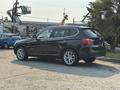 Black 2013 BMW X3 parked with a sleek design and alloy wheels showcasing its modern SUV features