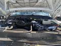The image shows the engine of a 2016 Ford F-350 SD with various components including hoses and a coolant reservoir visible