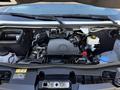 The engine compartment of a 2023 Mercedes-Benz Sprinter 2500 featuring the engine and various components including fluid reservoirs and electrical connections
