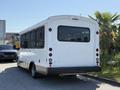 A white 2017 Chevrolet Express bus with large side windows and a rear bumper visible