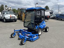 A 2011 New Holland G6035 compact tractor with a blue exterior and a glass cabin featuring a front-mounted mower attachment