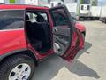 A 2015 Jeep Grand Cherokee with the front passenger door open showcasing the black interior and seating area