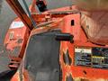 A close-up view of the control panel and engine hood of a 2012 Kubota F3680 showing its orange and black components