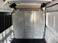 Interior view of a 2017 RAM Promaster showing a large metal partition in the back with a small access door