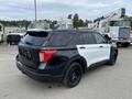 A 2021 Ford Explorer with a black and white paint scheme parked, featuring a sleek design and black wheels