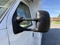A close-up of the side mirror of a 2012 Ford Econoline E-450 featuring a sleek black design and dual arms for support