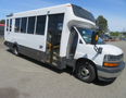 A white 2020 Chevrolet Express bus with large windows and a wheelchair accessible entry door