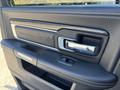 Interior door handle of a 2018 RAM 3500 featuring a metallic finish and a textured grip with the RAM logo visible on the armrest